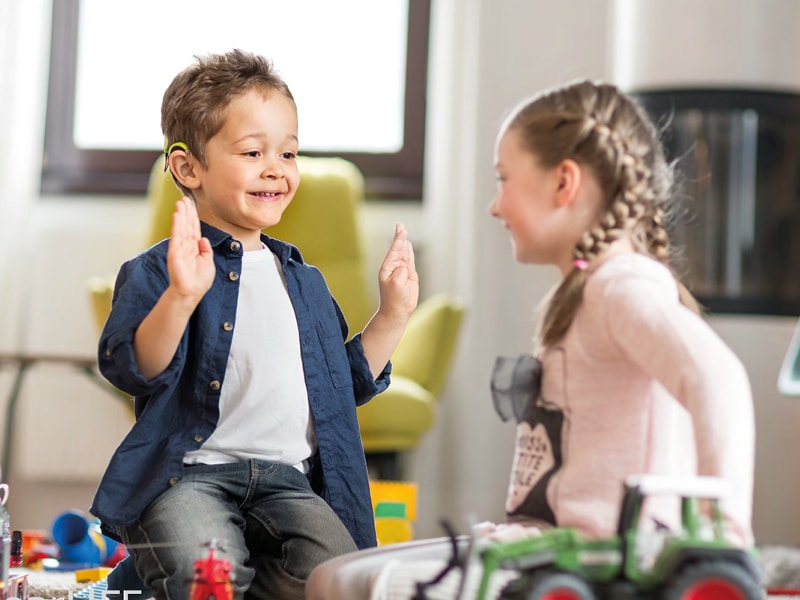 a child with bilateral cochlear implants plays as part of binaural hearing rehabilitation activities