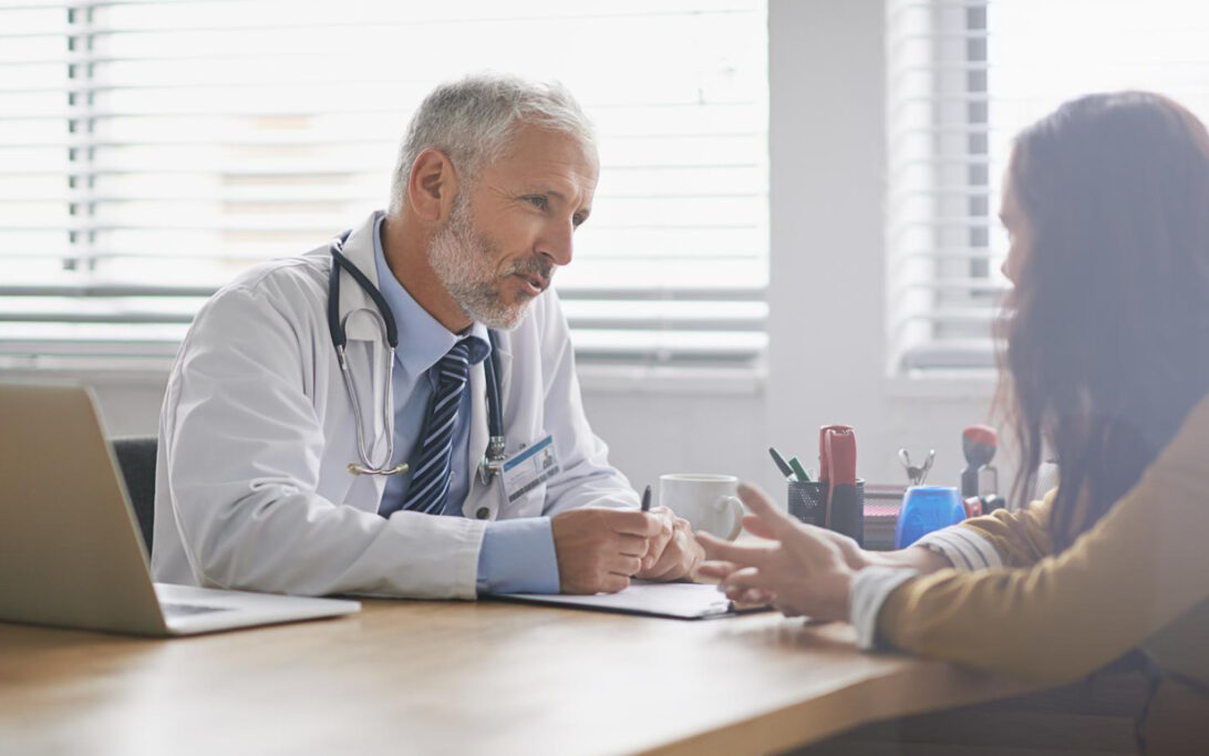an ENT doctor counsels a patient with balance disorders