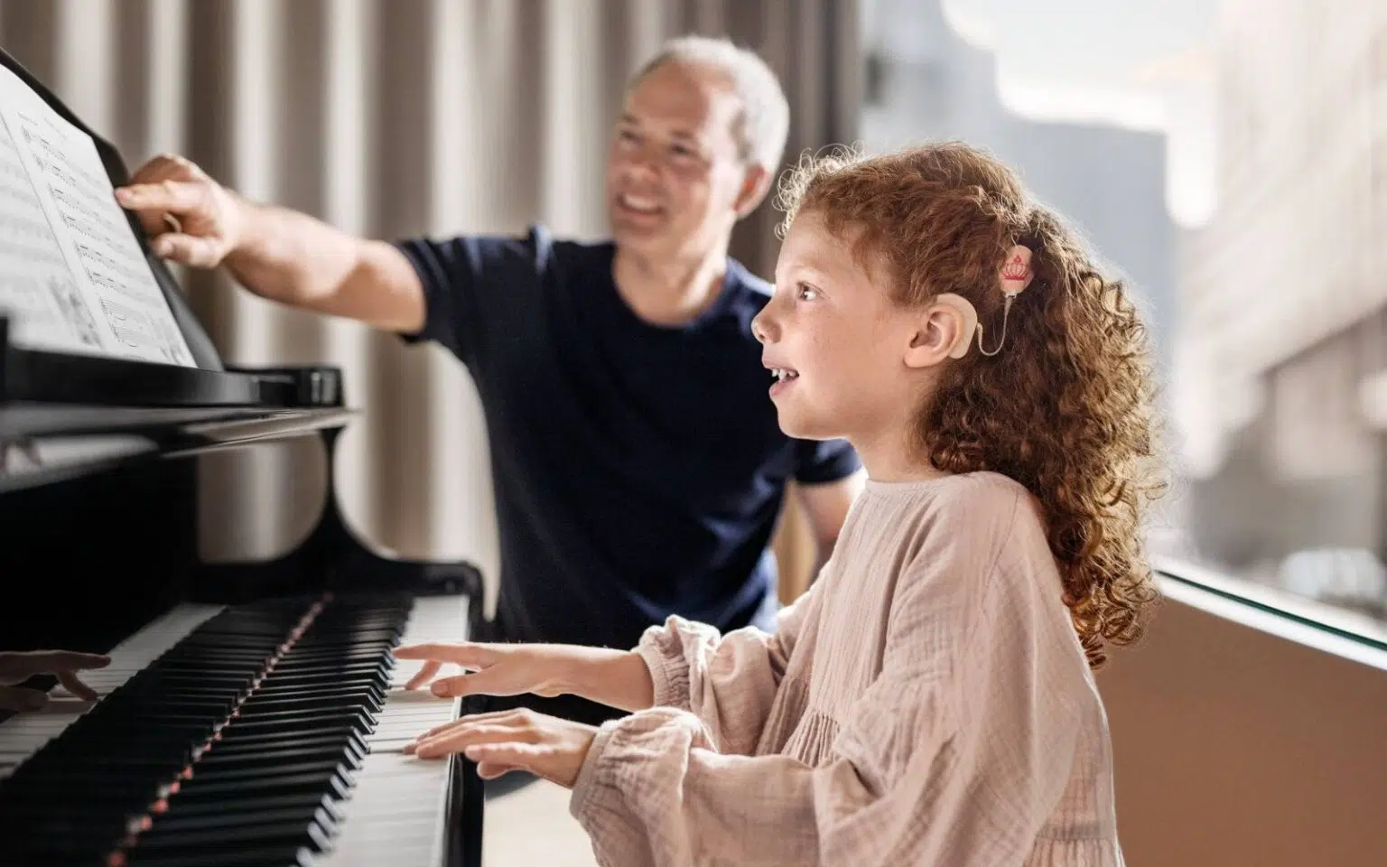 Little girl with the SONNET 3 Supercharged learning piano with her instructor