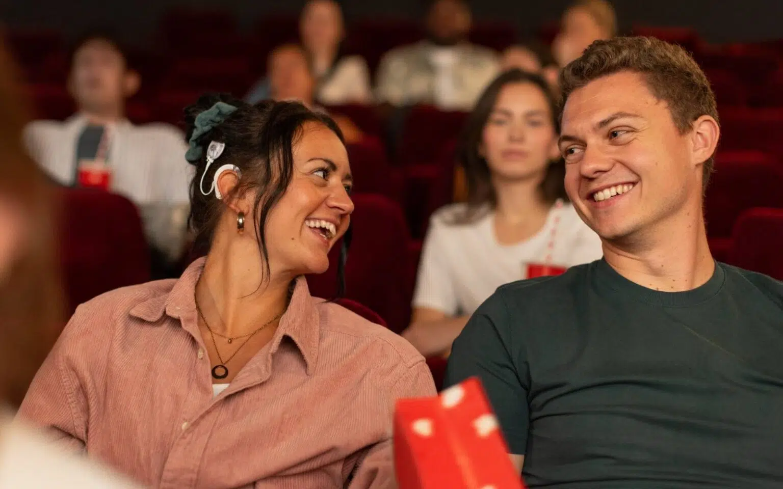 a woman with a SONNET 3 laughing while at the movies