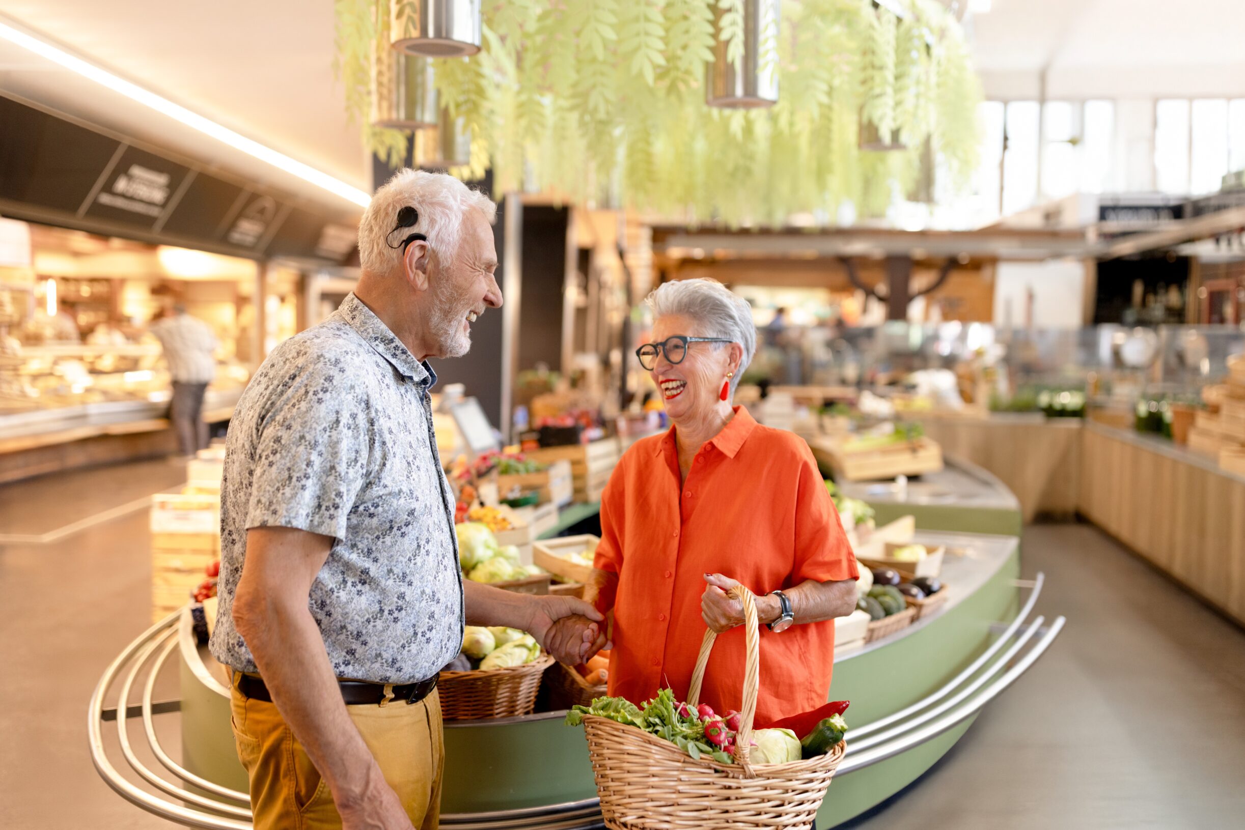Man with CI using the SONNET 3 Supercharged holds a woman's hand in the grocery store