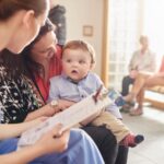 Baby sitting in a waiting room with mother and provider