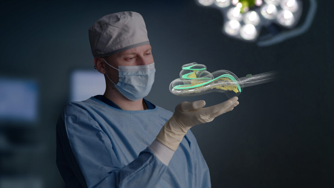 surgeon holding a graphic of a cochlea