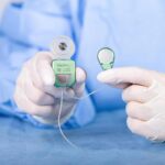 Close up of surgeon holding TICI UNICO implant in hands